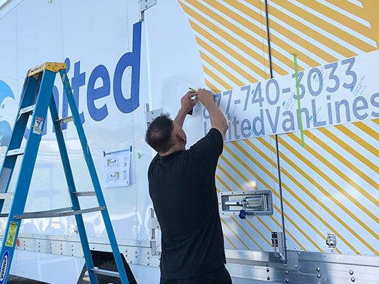 Installing viny lettering on side of a truck