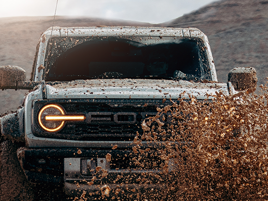 Truck splashing in mud showing the windshield protection film