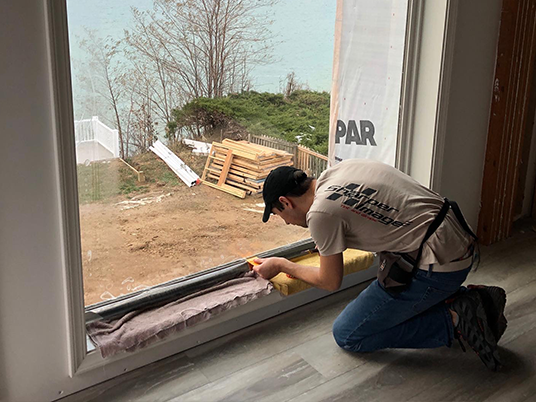 Applying window tint film to a house